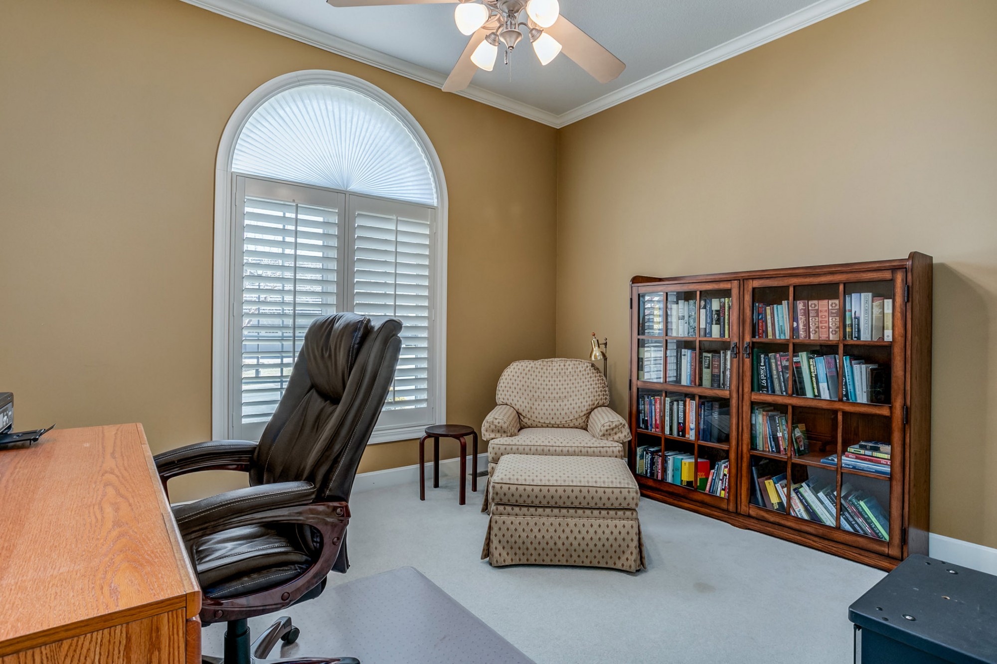 Also on the main level is the second bedroom, perfect for use as a home office, offering crown moulding and lighted ceiling fan.