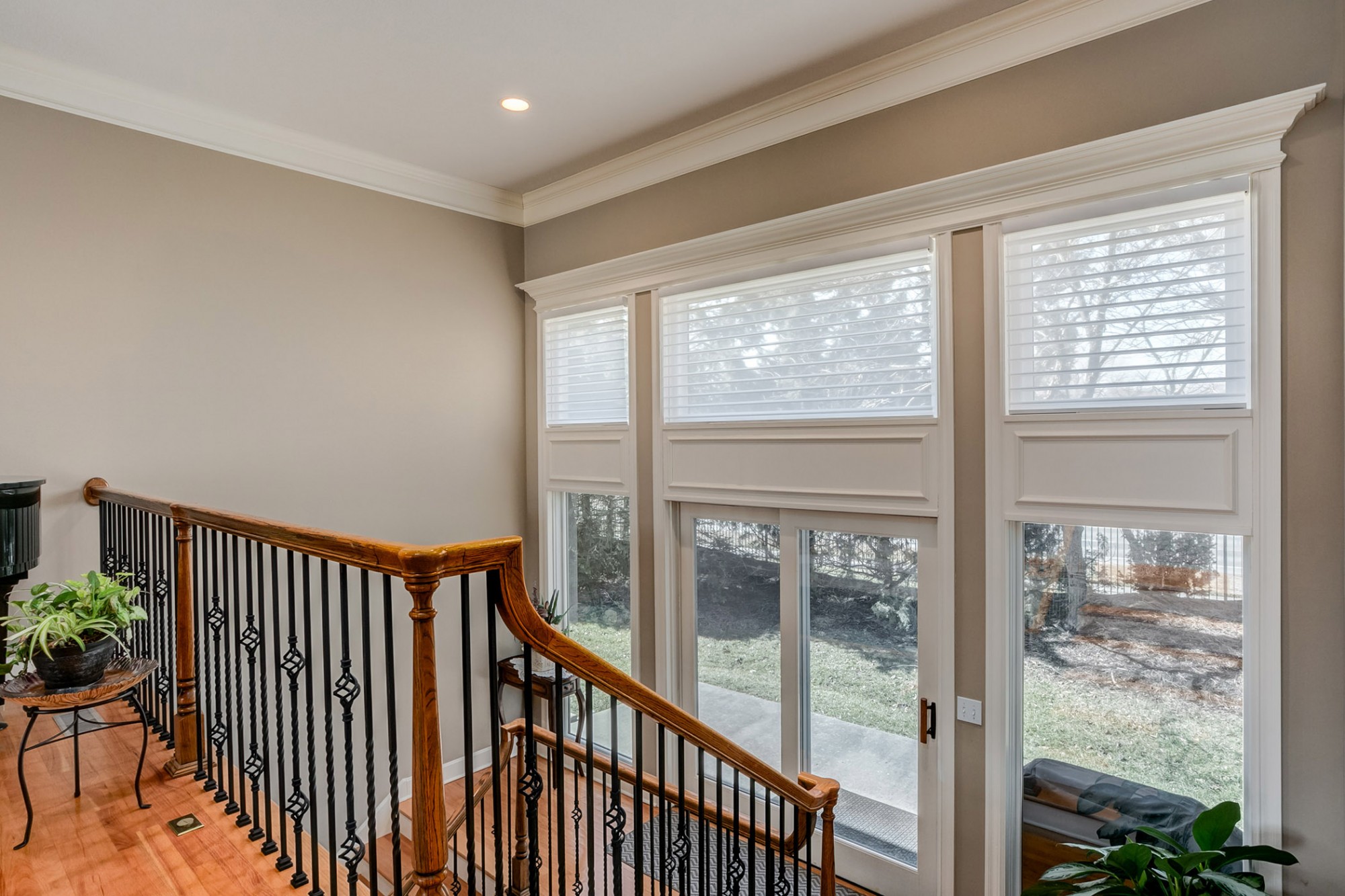 Large landing with walk-out, located between the main & lower levels, has a wall of windows, including a patio door leading to the patio & rear yard.