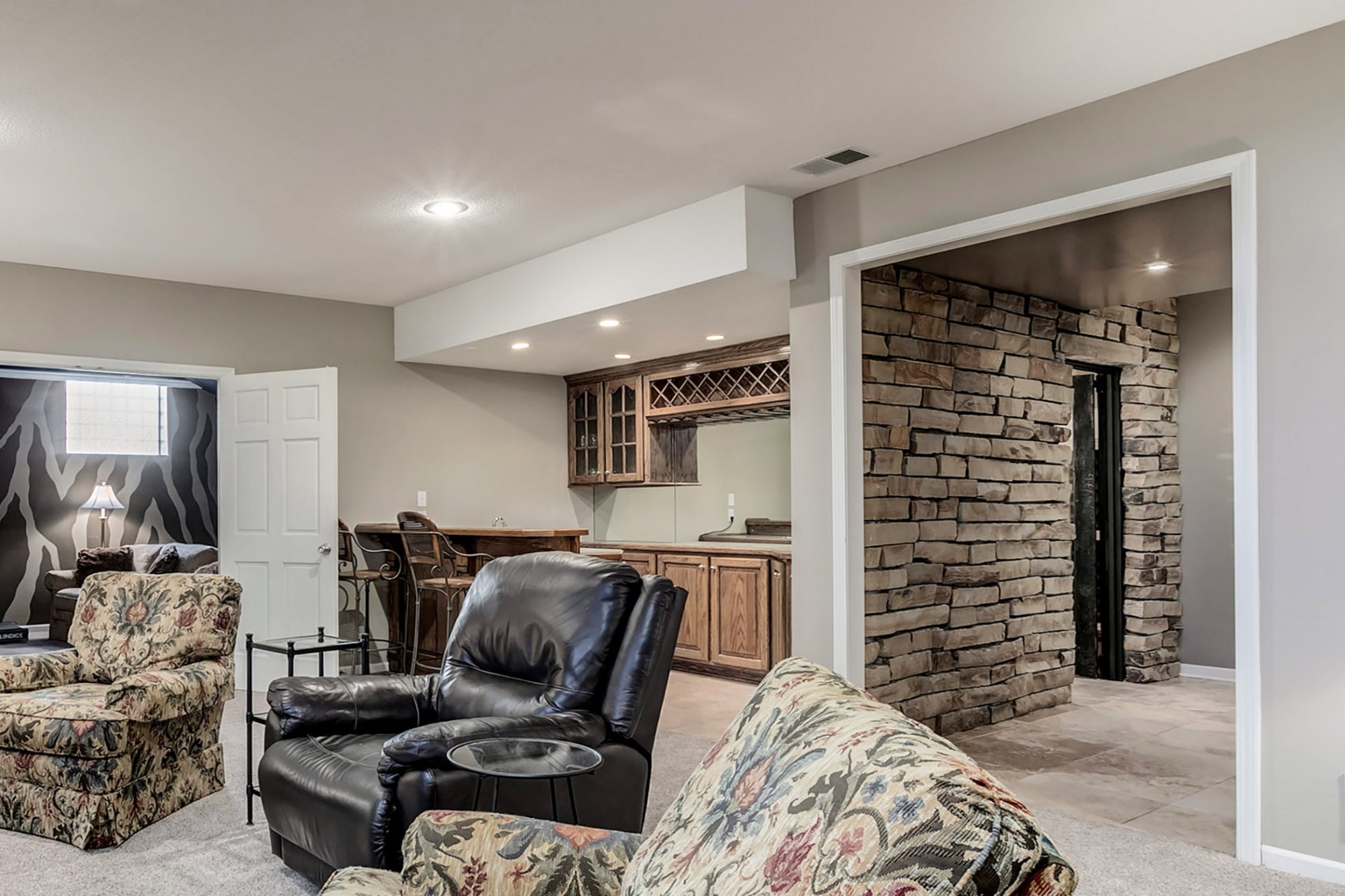 Adjacent to the rec room is a custom stacked stone wall leading to the remarkable wine cellar and tasting room.