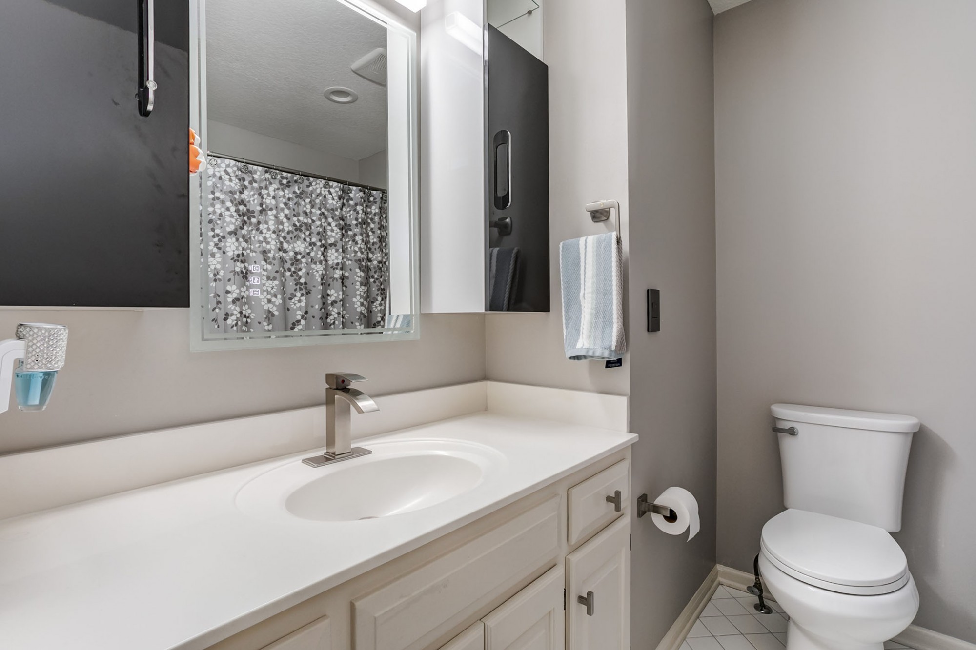 2nd bedroom's en-suite bath with ample storage, tile flooring and tub/shower combo.