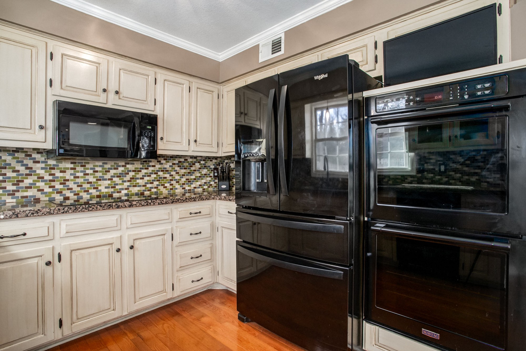 Energy efficient induction cooktop, French door refrigerator with dispensers, dishwasher, built-in microwave, and double wall ovens.
