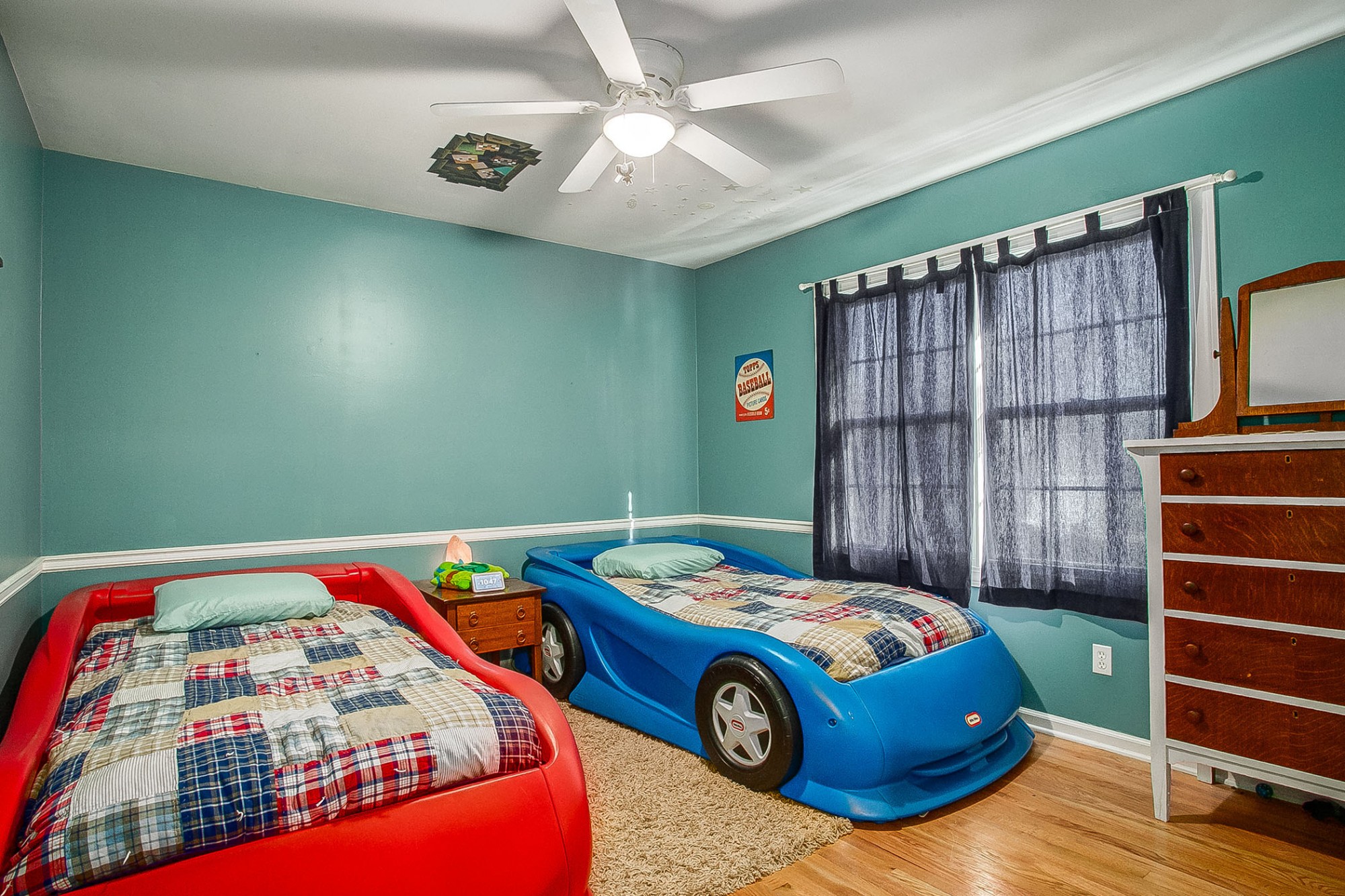 Secondary bedrooms feature hardwood floors, lighted ceiling fans, and walk-in closets.