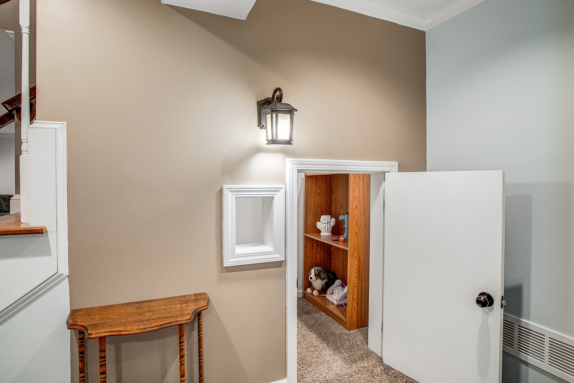 Beneath the staircase is an enchanting and quaint playhouse with its own window and porch light, perfect for little imaginations.